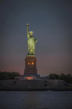 The statue of liberty at dusk Stock Photos