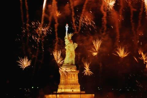 Statue of Liberty with fireworks exploding in background 写真素材