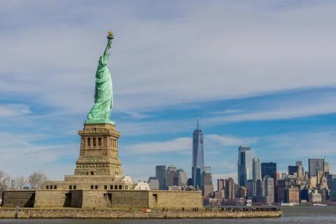 The Statue of Liberty on Liberty island with New York City Manhattan downtown Stock Photos
