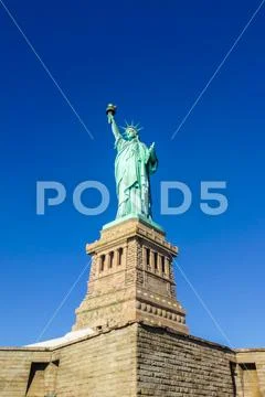 Statue of Liberty at perfect weather conditions blue sky copper torch Stock Photos