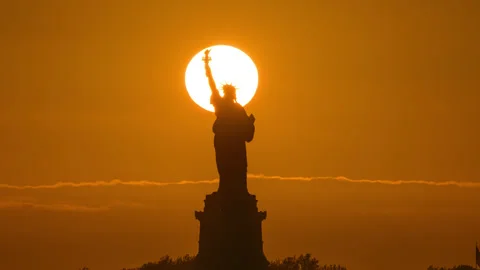 Statue of Liberty Setting Sun Zoom Out Stock Footage 156589113