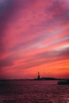 Statue of liberty at sunset Photos