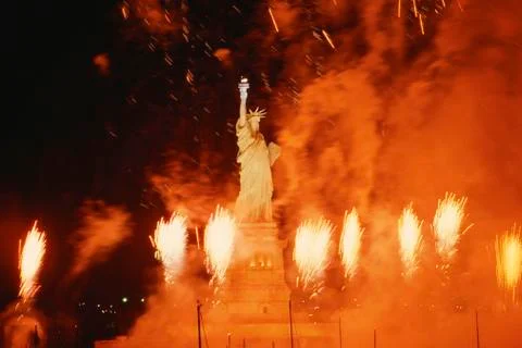 Statue of Liberty surrounded by exploding fireworks Stock Photos