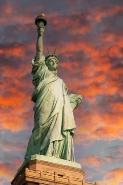 Statue of Liberty on under a burning dramatic sky Stock Photos