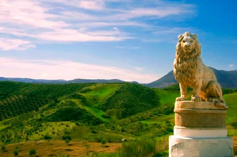Statue of lion in the background of fields Stock Photos