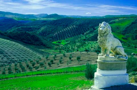 Statue of lion in the background of olive fields Stock Photos