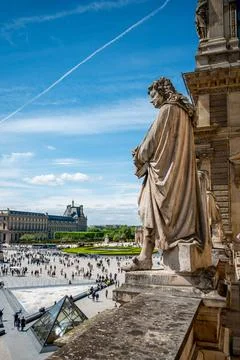 Statue looking down at the Square of Louvre Palace, Paris Statue looking ... Foto stock