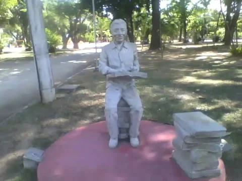 Statue of a man with a book, and several books on the floor closed Stock Footage 163681304