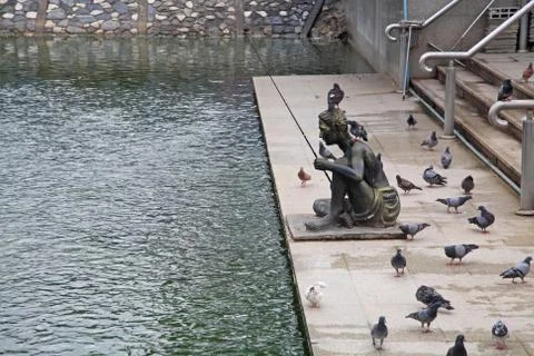 Statue of man with fishhook Stock Photos