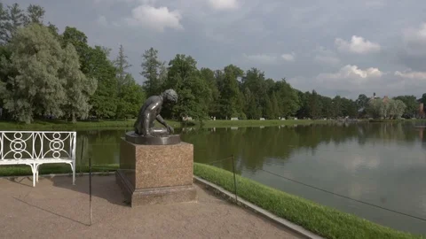 Statue of a man in a garden by the lake Stock Footage 108306314