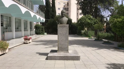 Statue of a man in a school yard in Larnaca Stock Footage 89617551