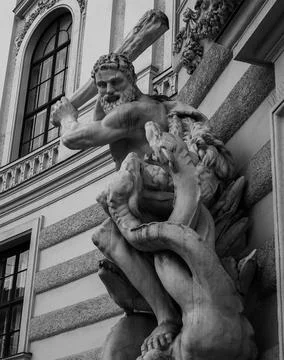 Statue of man versus dragons Stock Photos