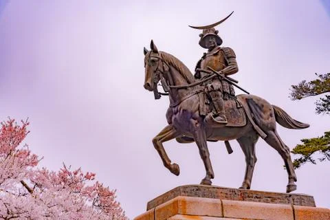 A statue of Masamune Date on horseback in cherry blossom Stock Photos