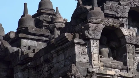 Statue of meditating Buddha. Ancient Borobudur Buddhist temple. Java Indonesia Stock Footage