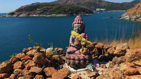 Statue on the mountain, stones on the sea phuket sea thailand Stock Footage