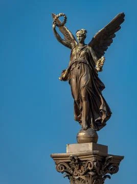 Statue of a muse on a column in Prague Stock Photos
