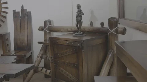 Statue on the old model designed box and a chair. Stock Footage 97267795