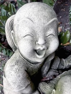 Statue of an old smiling boy Stock Photos