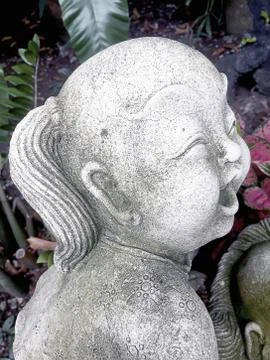 Statue of an old smiling boy Stock Photos