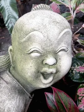 Statue of an old smiling boy Stock Photos