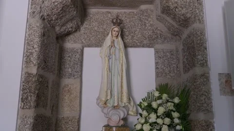 Statue of Our Lady of Fatima with White Roses in Stone Niche Stock Footage 340181923