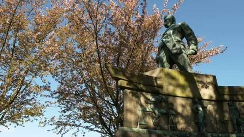 Statue in park with flowering trees in the background Stock Footage 81104859