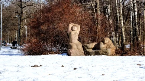 Statue in the park, with people passing by in the background Stock Footage 99118040