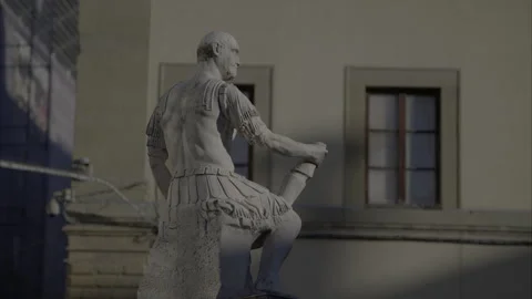 Statue of roman fighter with two young men playing music Stock Footage 299451449