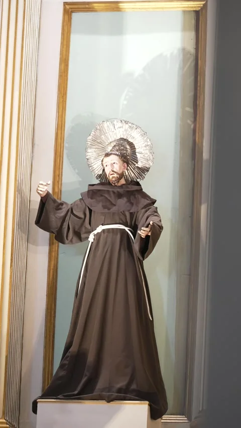 Statue of Saint in Brown Robe Behind a Column Inside a Church Stock Footage 312748941