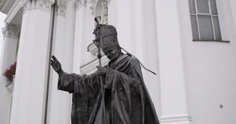 Statue of Saint John Paul II with raised hand in blessing on central square. 库存影片 314000255