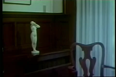 Statue on shelf exploding in slow motion Stock Footage 11353636
