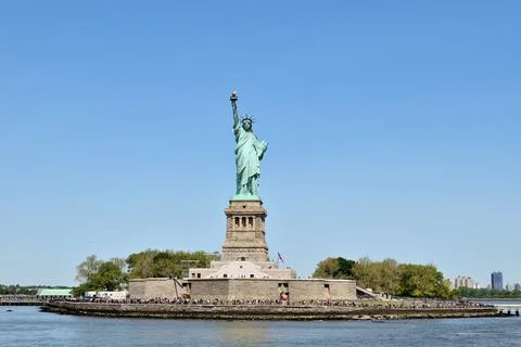 The statue is surrounded by a large crowd of people Stock Photos