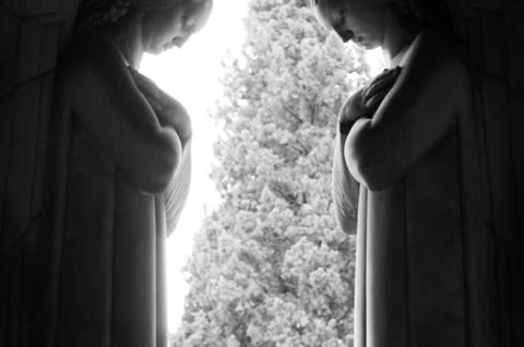 Statue of two angels facing each other Stock Photos