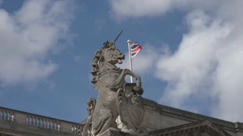 A statue of a unicorn and the British flag behind it. Stock Footage 114987985