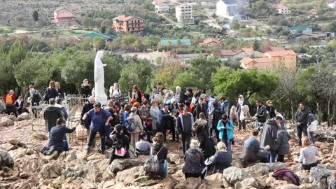 Statue of the Virgin Mary on Mount Podbrdo surrounded by pilgrims. Stock Footage 239576793