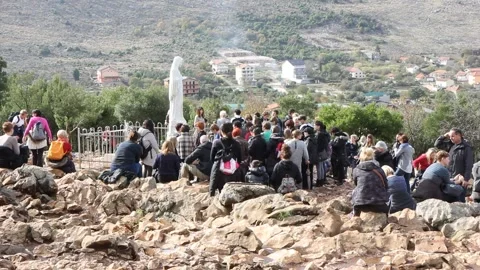 Statue of the Virgin Mary on Mount Podbrdo surrounded by pilgrims. Stock Footage 239576810
