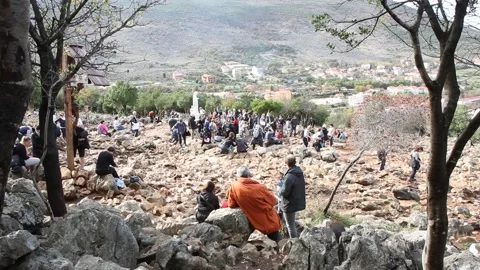 Statue of the Virgin Mary on Mount Podbrdo surrounded by pilgrims. Stock Footage 239576869