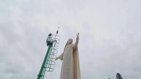 Statue of the Virgin Mary in Varazze Under Maintenance With Crane and Cloudy Sky Stock Footage 336774975