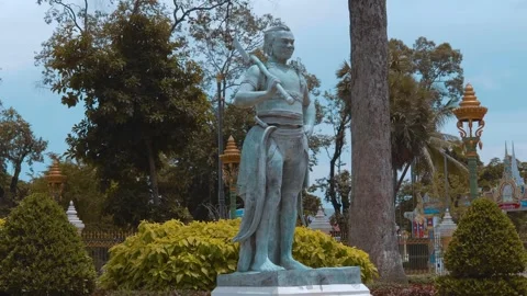 A statue of warrior with an axe slung over his shoulder is standing in the park Stock Footage 318670119