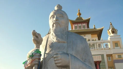 Statue of a wise man in a front of buddhist temple Stock Footage 89839021