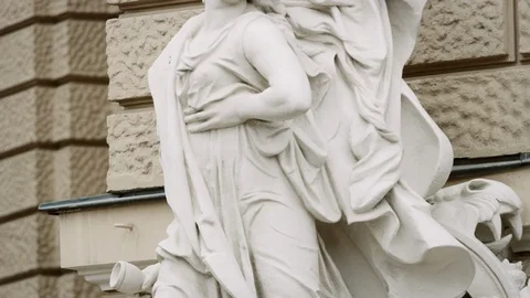 Statue of woman in dramatic pose with cherub hovering above slow tilt up Stock Footage 122541668