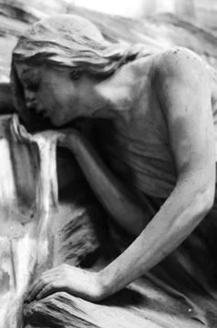 Statue of a young man drinking at a stream Stock Photos