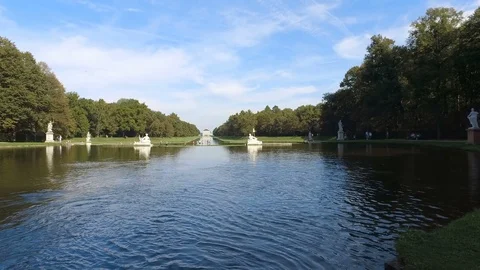 Statues around the man-made pond in Nymphenburg palace on a summer sunny day Stock Footage 106600908