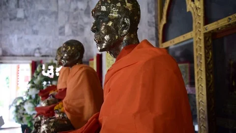 Statues of Buddhist Monks Adorned with Gold Stock Footage 85002510