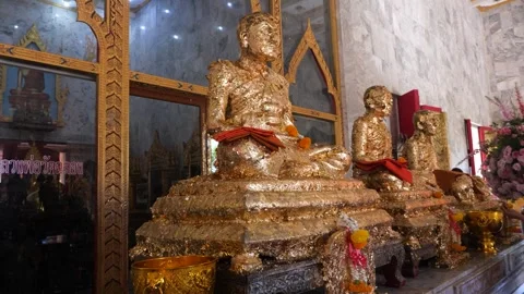 Statues of monks covered with thin golden leaves in temple Stock Footage 285394920