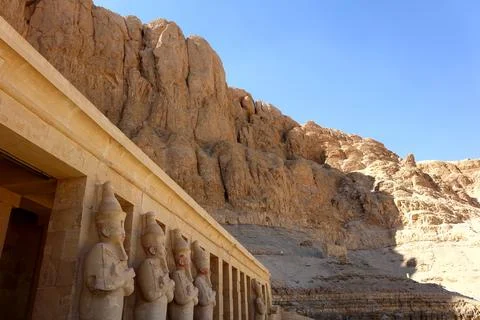 Statues at the Mortuary Temple of Hatshepsut Against the Backdrop of Valley.. Stock Photos