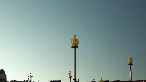 Statues of thinkers on poles in Nice on Place Massena Stock Footage 200001372