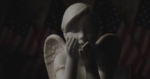Statuette of an angel on the background of American flags Stock Footage 137866166