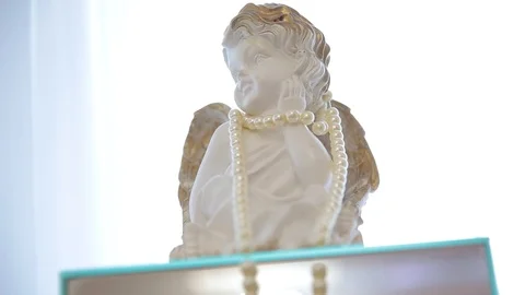 Statuette of angel with pearl corals. Stock Footage 127302191