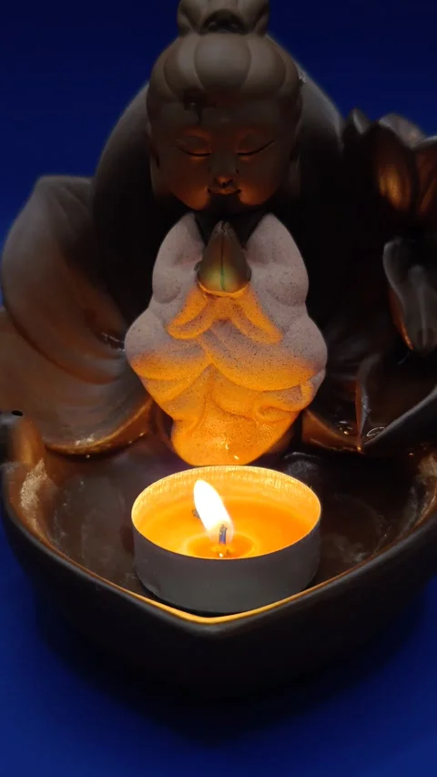 Statuette with a burning candle. Видео 312279292